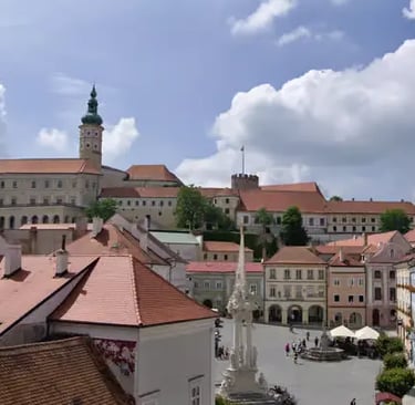 View from the town square towards Mikulov Castle, showing the blend of Baroque architecture and historic charm