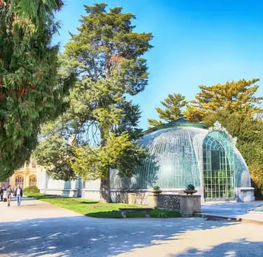 The historic 19th-century cast-iron greenhouse (Palm House) in the gardens of Lednice Chateau, South Moravia.