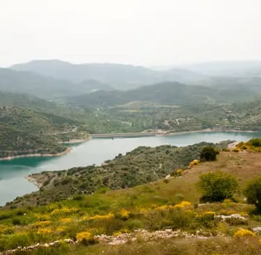 Turquoise Siurana reservoir surrounded by green hills in Priorat Catalonia