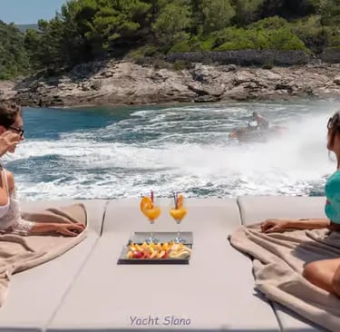  Guests on Gulet stern sunbathing pad watching water sports in a sheltered Croatian bay