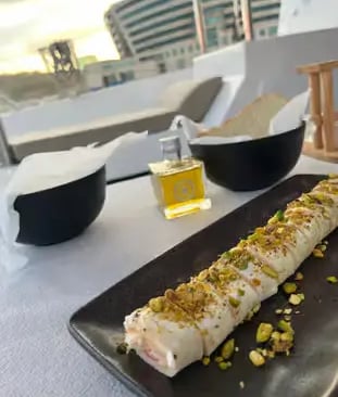 Gourmet pistachio dessert served on deck during Barcelona Mediterranean sailing tour