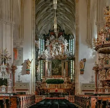Interior view of a historic cathedral with a golden altar in Graz.