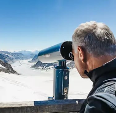 Close-up of tourist using telescope at Sphinx Terrace Jungfraujoch Swiss Alps