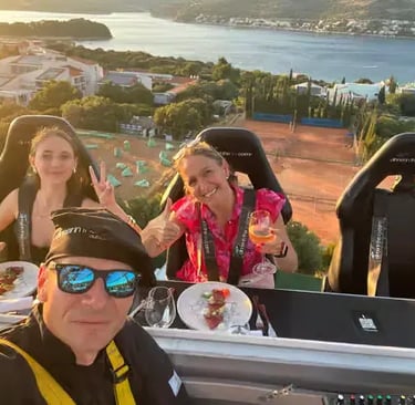 Three guests selfie on elevated Dinner in the Sky Dubrovnik platform above Adriatic Sea