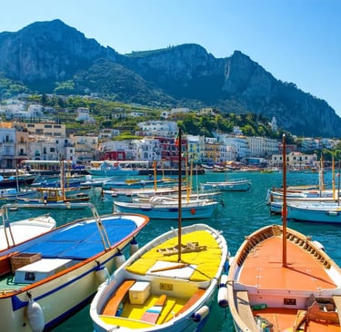 Traditional gozzo boats docked in Marina Grande harbor below Monte Solaro in Capri