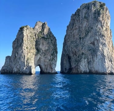 Faraglioni Rocks of Capri rising from deep turquoise Mediterranean water under a clear blue sky