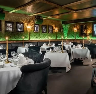 The cozy and stylish restaurant dining area at Funky Fox bar with ambient green lighting in Courchev