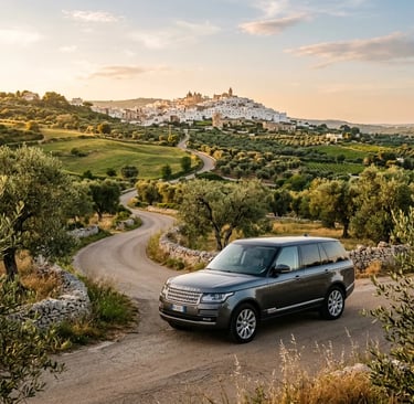 Luxury private transfer vehicle on scenic Puglia countryside road near hilltop village