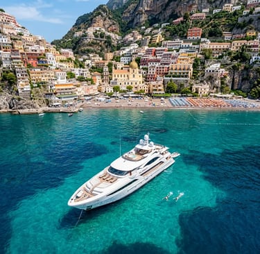 Luxury yacht anchored at Positano Spiaggia swim stop on Capri boat tour with swimmers