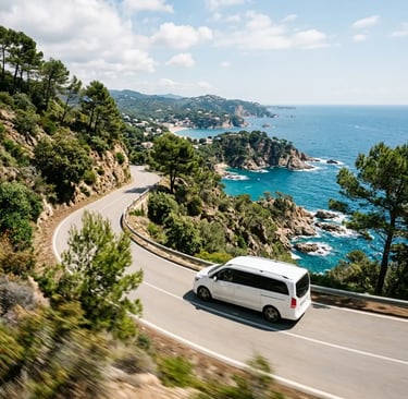 Private minivan driving a winding Costa Brava cliff road from Barcelona to Tossa de Mar
