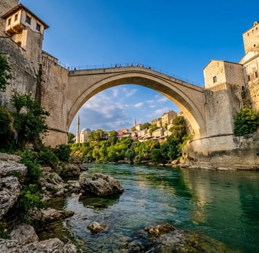 Stari Most bridge in Mostar seen from below with emerald Neretva River and old town beyond