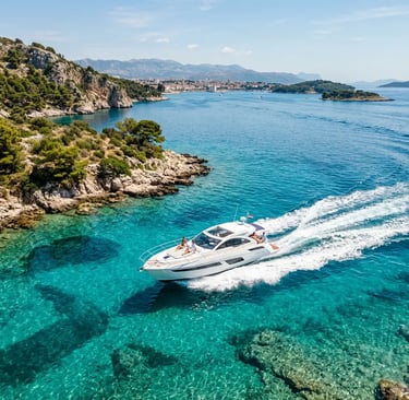 Private boat cruising turquoise Adriatic waters along Dalmatian coast near Split Croatia
