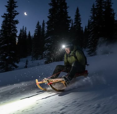 Thrilling night sledding down a snowy run in St. Anton illuminated by a headlamp.