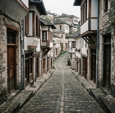 Empty cobblestone alley lined with Ottoman stone houses in Gjirokastër old town Albania