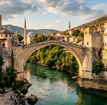 Stone arch of Stari Most bridge over emerald Neretva River with minarets and old houses in Mostar