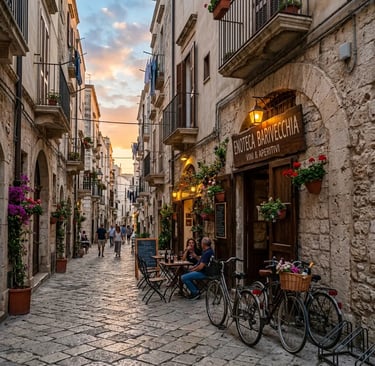 Cobblestone street in Bari old town with enoteca wine bar at golden sunset
