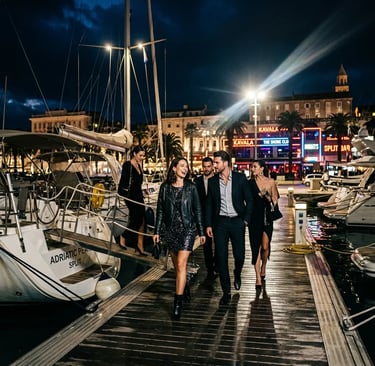 Stylish VIP group stepping off sailboat onto Split marina dock heading to nightclub