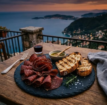 Slavonian pepper-spiced cured meat with grilled bread on slate plate overlooking Adriatic coast