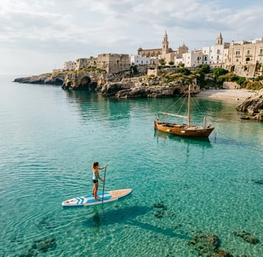Woman on SUP paddleboard gliding over crystal-clear water near Monopoli coast Puglia