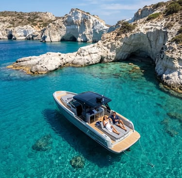 Couple relaxing on Saxdor 320 boat anchored in turquoise waters near Kleftiko white cliffs Milos