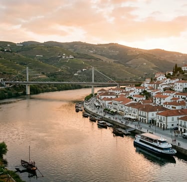 Peso da Régua waterfront at sunset with Douro river cruise boat docked and terraced vineyards