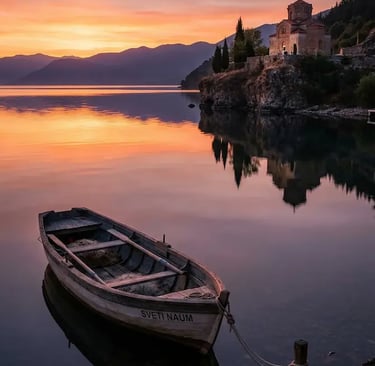 Lake Ohrid North Macedonia at sunrise, wooden Sveti Naum boat, Byzantine church on rocky shore