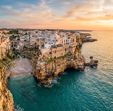 Aerial view of Polignano a Mare old town on limestone cliffs at sunset