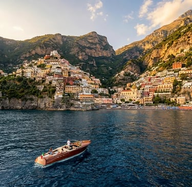 Positano pastel village cascading down hillside viewed from a private boat offshore