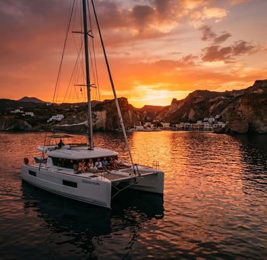 Premium Milos catamaran cruise at golden sunset, returning from Kleftiko boat tour Greece