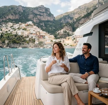 Couple relaxing with espresso on luxury catamaran deck along Amalfi coastline