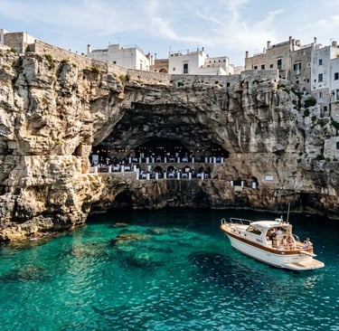 Luxury boat anchored near Grotta Palazzese sea cave in Polignano a Mare with turquoise water
