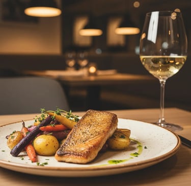 A gourmet grilled salmon fillet served with roasted vegetables at the Aqua Dome restaurant, offering
