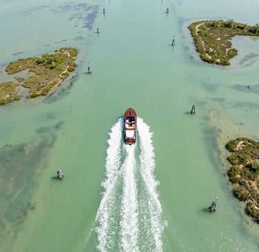 Aerial view of Riva Aquariva cutting through the Venetian Lagoon between marshy islands