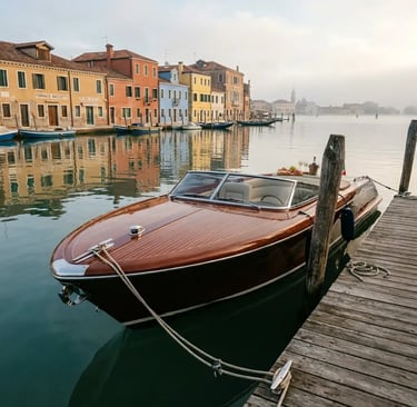 Riva Aquariva moored at wooden dock on Murano island with colorful buildings and morning fog