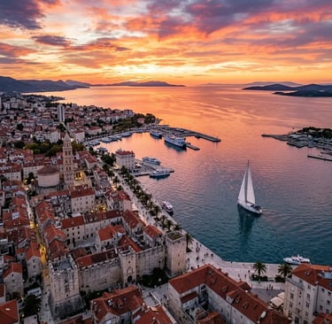 Aerial drone view of sailboat departing Split old town harbor at golden sunset