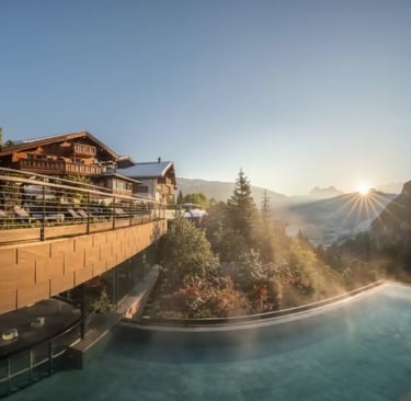 Steaming outdoor infinity pool at a 5-star Val Gardena wellness resort during a golden hour sunset i