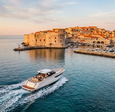 Private speedboat cruising past Dubrovnik old town walls at golden hour