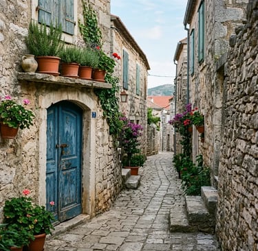 Narrow stone alley with blue wooden door and potted herbs in Milna village on Brač island