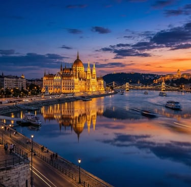 Budapest Parliament glowing at dusk reflected in the Danube River with Chain Bridge