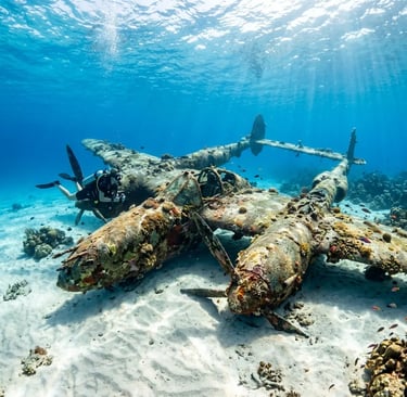 Diver exploring sunken military plane on sandy seabed in shallow water near Trogir Croatia