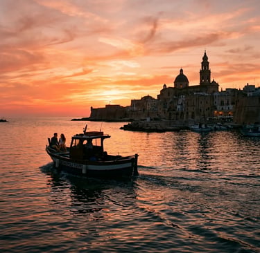 Couple on Monopoli Tours boat sailing toward old town cathedral during vivid orange Puglia sunset
