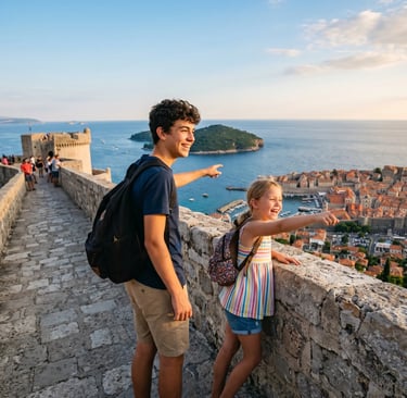 Teenage boy and young girl on Dubrovnik city walls pointing at Adriatic Sea and old town below