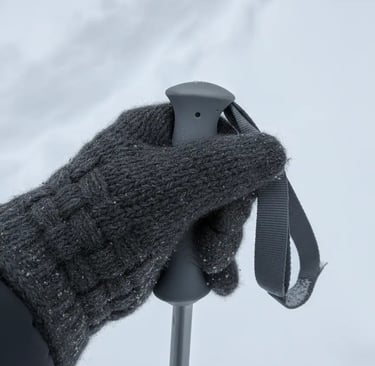 Textured gray gloves and ski equipment matching a monochromatic ski look.
