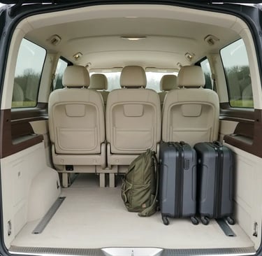 Spacious trunk of a private travel van loaded with suitcases and a backpack, showing ample luggage s