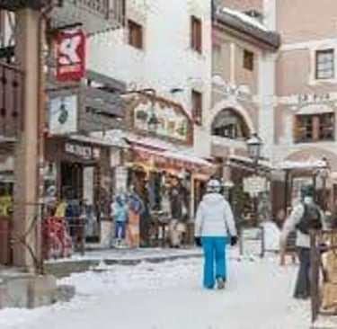 Pedestrians walking through the car-free village center of Avoriaz during winter season.