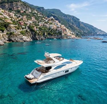White Azimut luxury yacht anchored in turquoise water near colorful Amalfi Coast cliffs