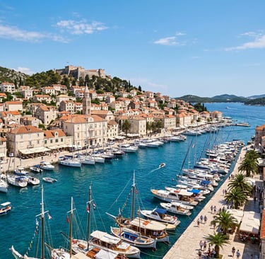 Hvar Town harbour with fortress, stone buildings, sailboats and blue Adriatic Sea
