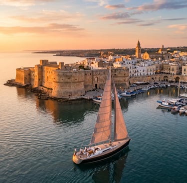 Sailboat passing Otranto Aragonese castle at golden hour sunset, Puglia Italy