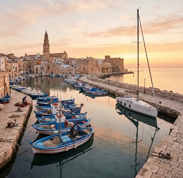 Fishing boats and sailboat docked in Monopoli harbor at golden sunrise