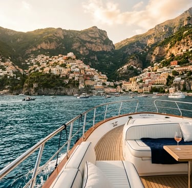 Luxury yacht deck with white cushions approaching Positano village on the Amalfi Coast